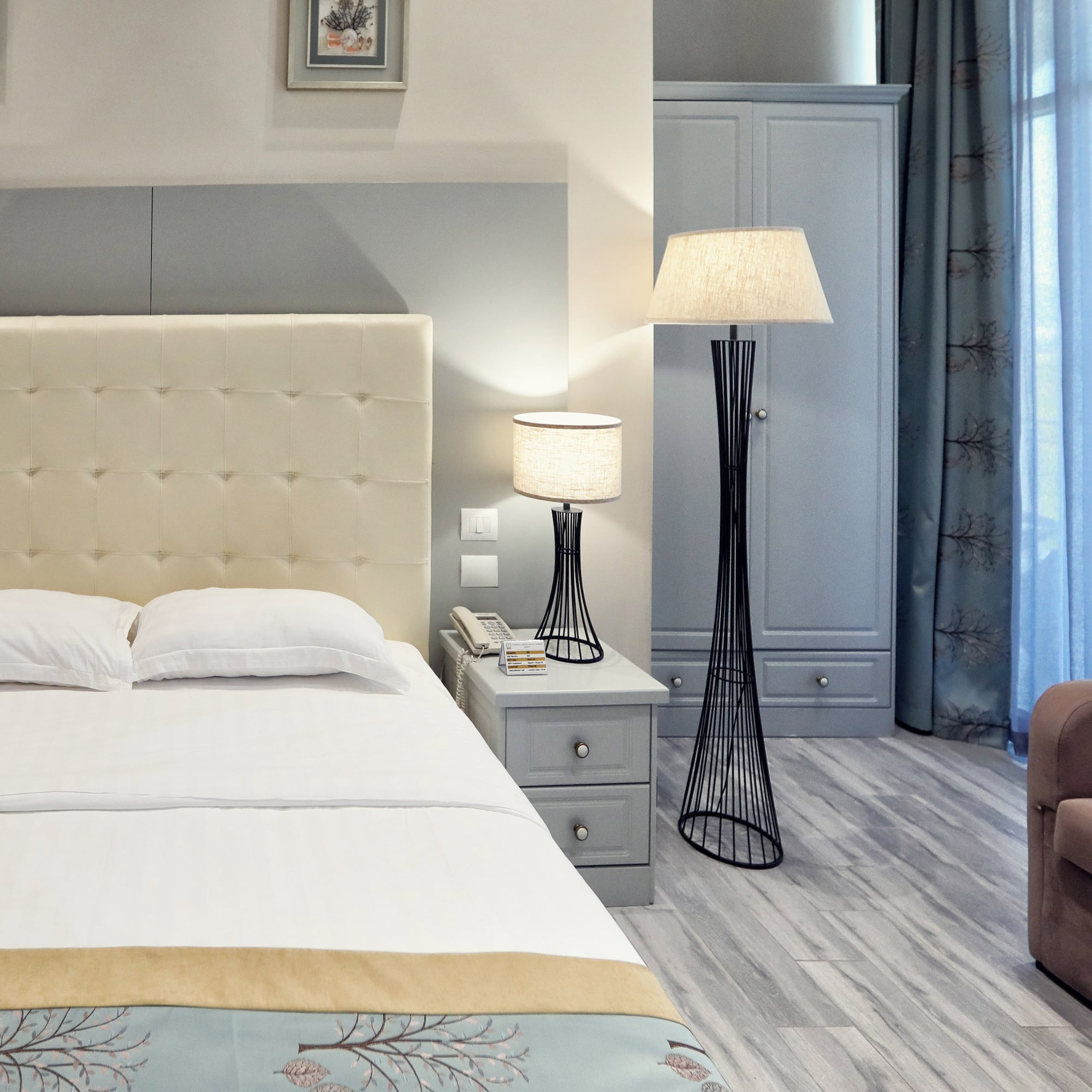 a bedroom with a bed and a lamp