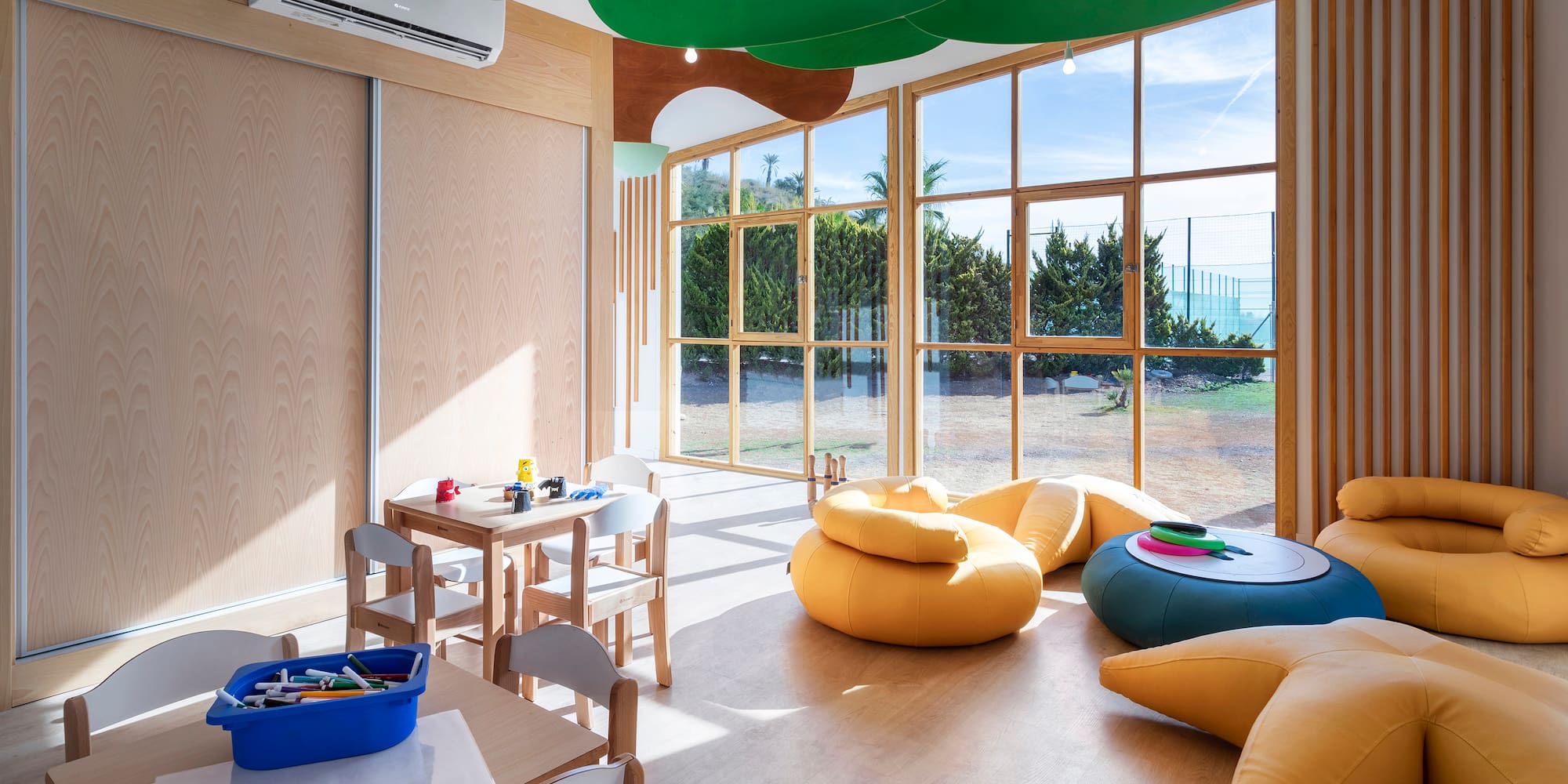 a room with a large window and chairs and tables