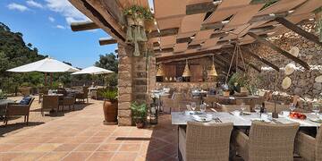 a patio with tables and chairs