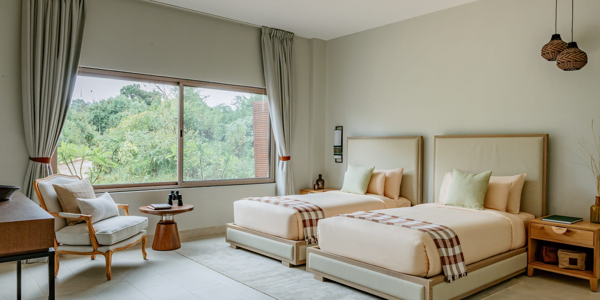 a room with two beds and a chair