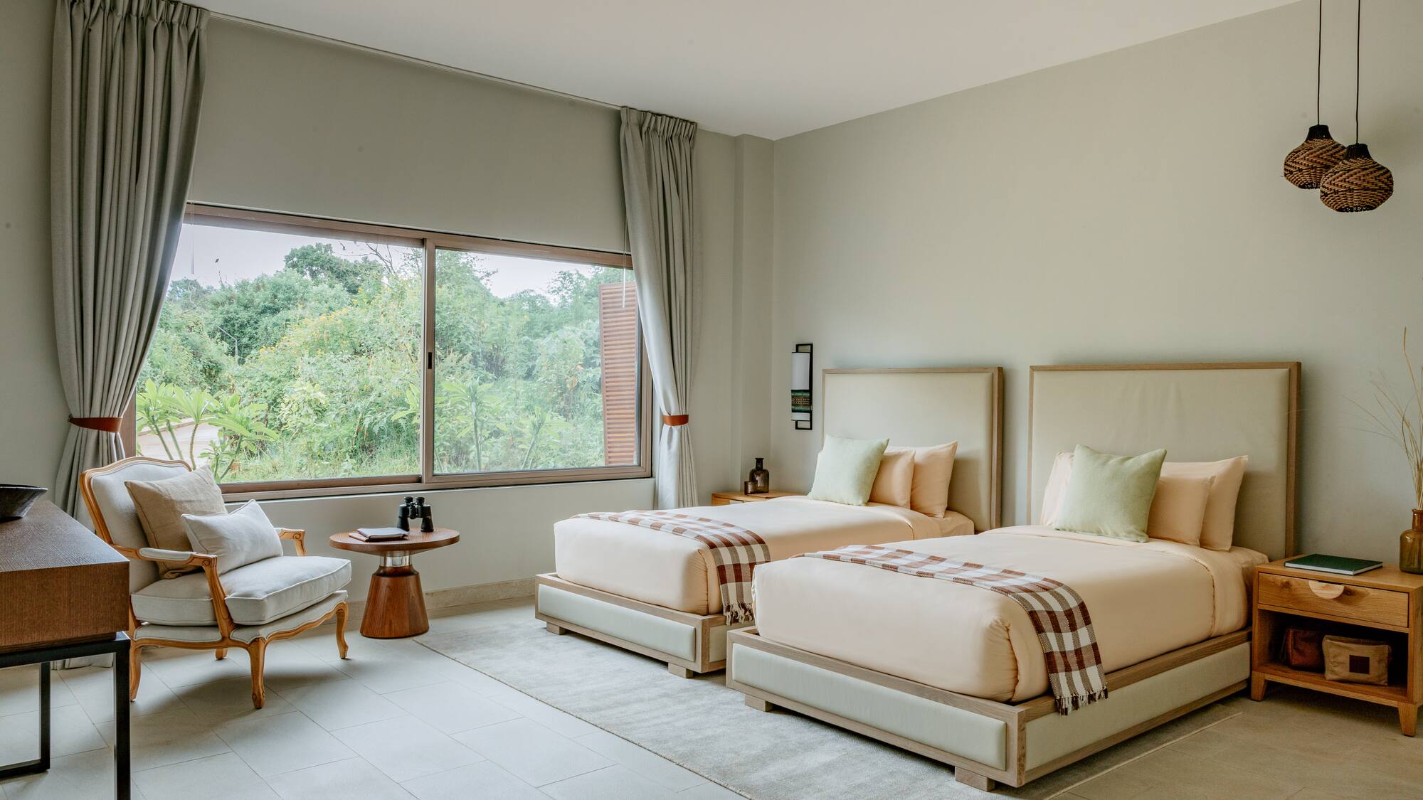 a room with two beds and a chair