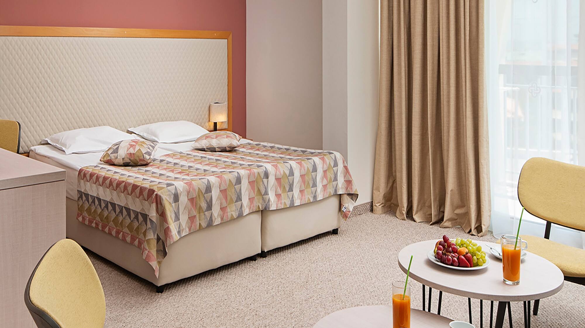 a room with a bed and a table with food and drinks