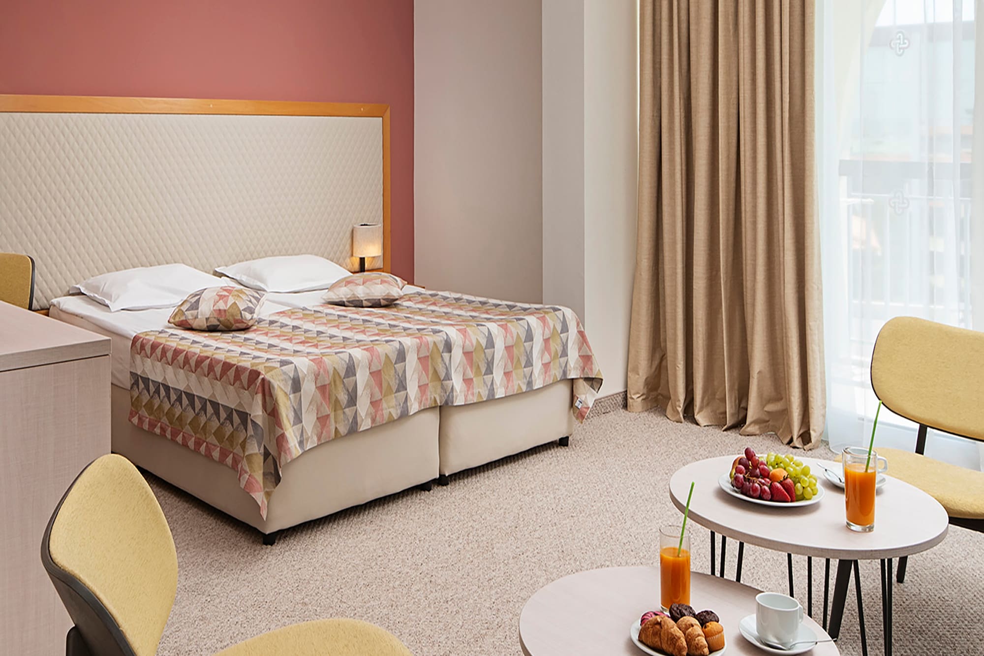 a room with a bed and a table with food and drinks