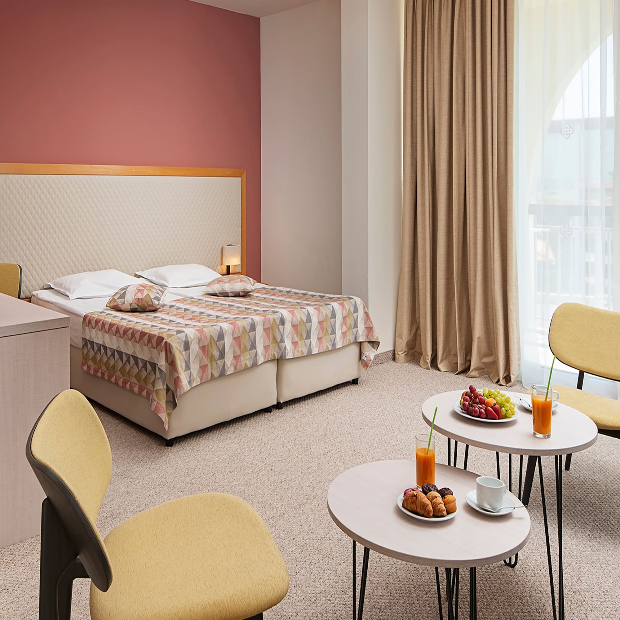 a room with a bed and a table with food and drinks