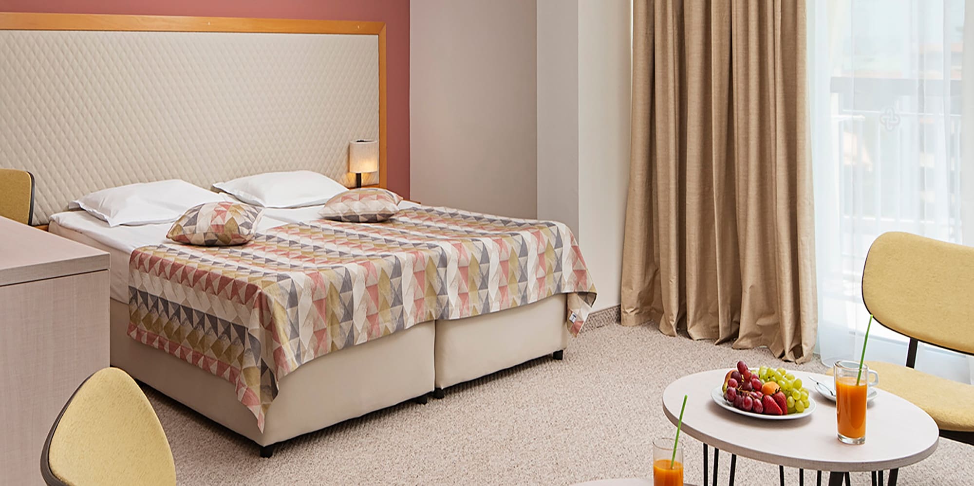 a room with a bed and a table with food and drinks