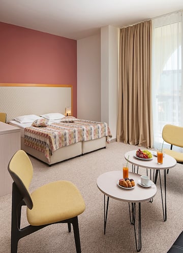 a room with a bed and a table with food and drinks