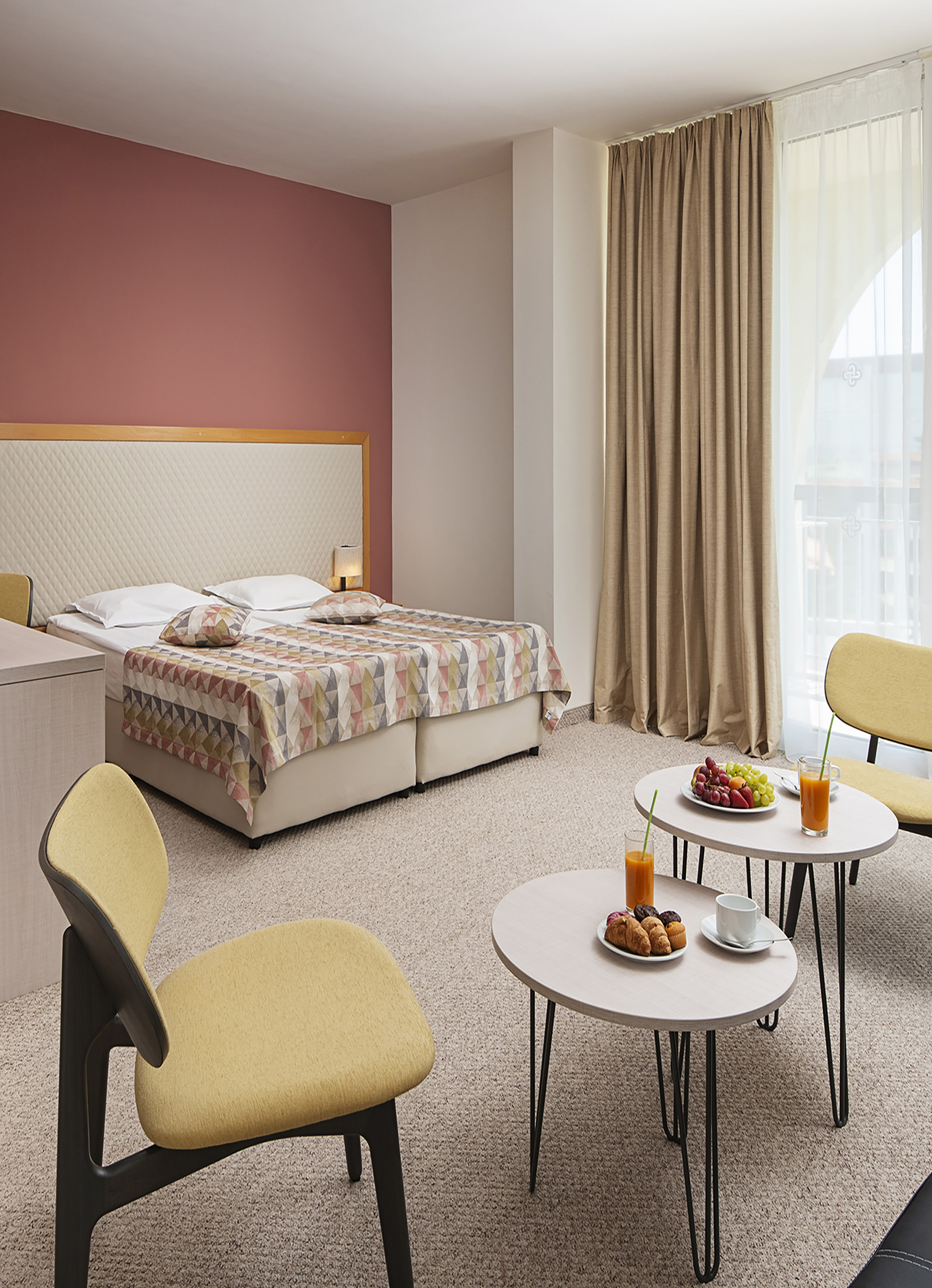 a room with a bed and a table with food and drinks