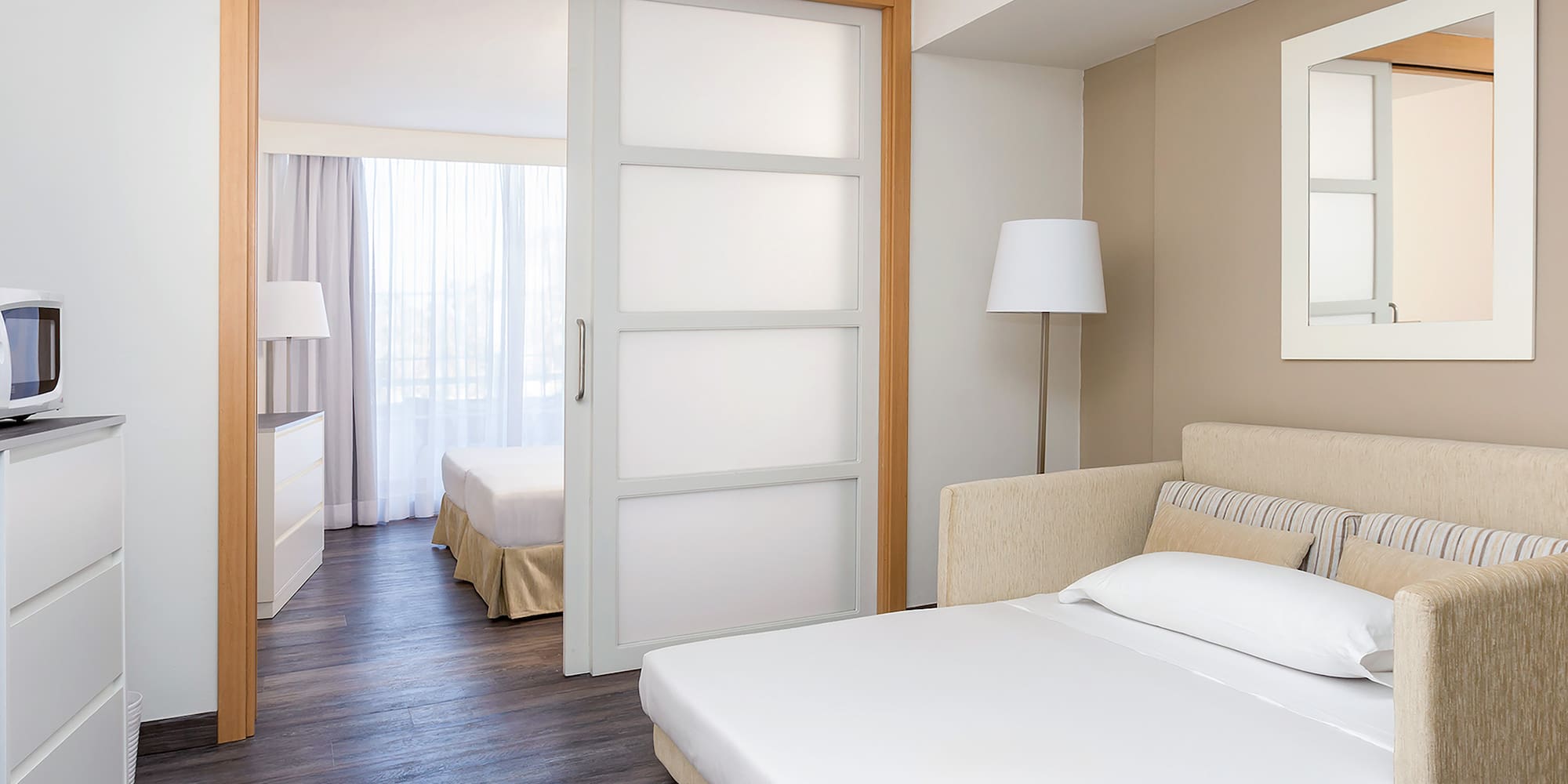 a bedroom with a bed and a lamp