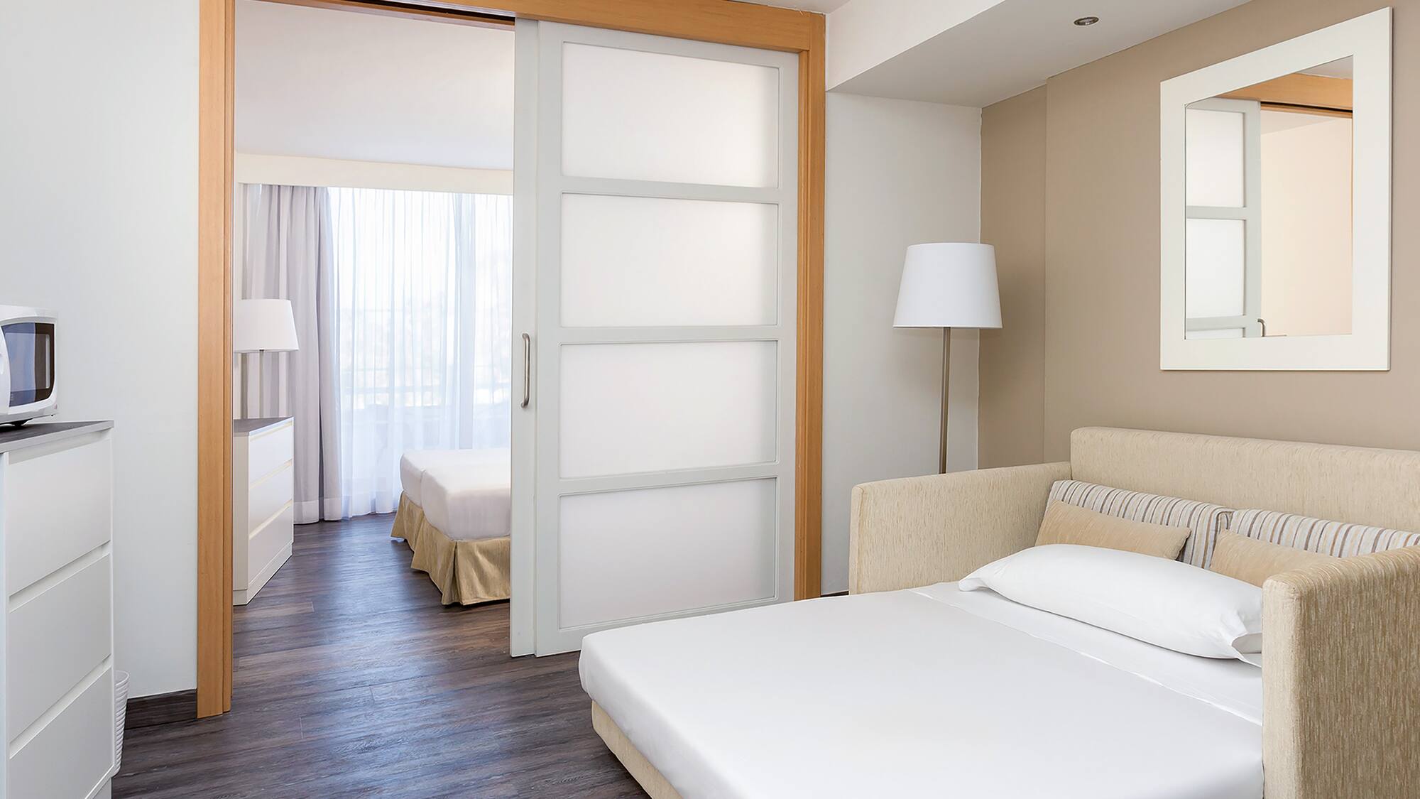 a bedroom with a bed and a lamp