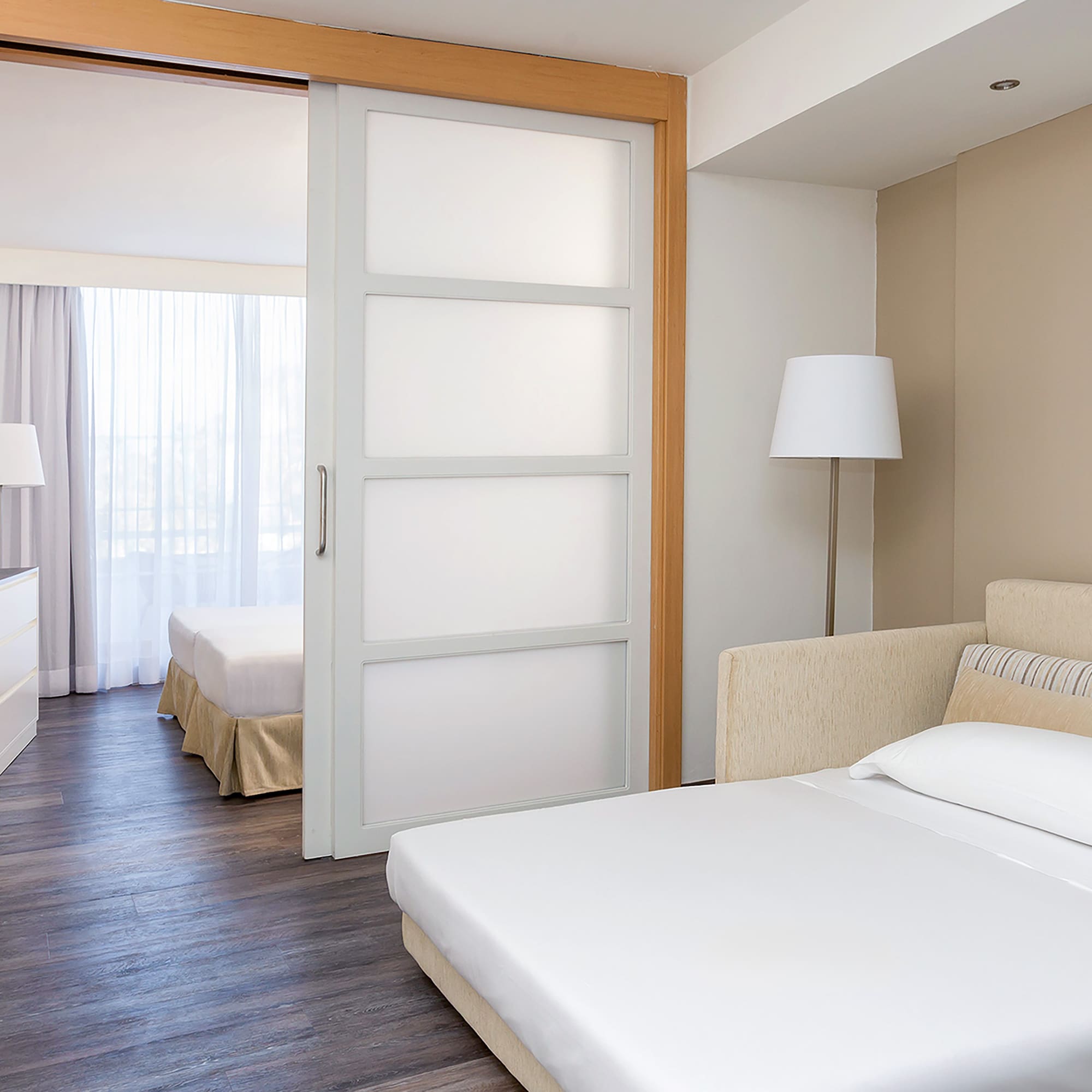 a bedroom with a bed and a lamp