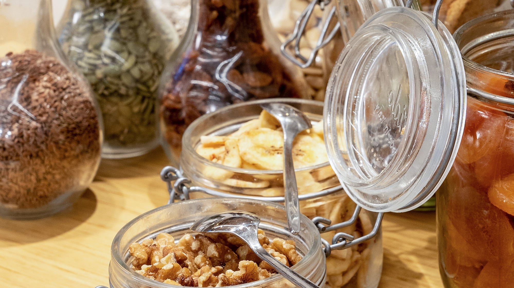 a group of glass jars with food in them