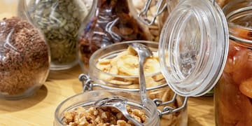 a group of glass jars with food in them