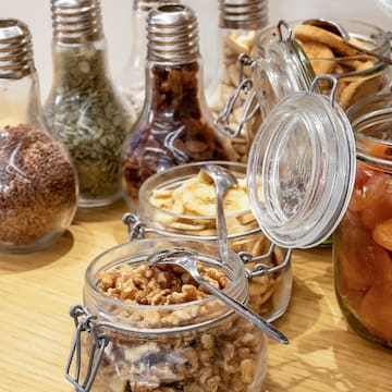 a group of glass jars with food in them