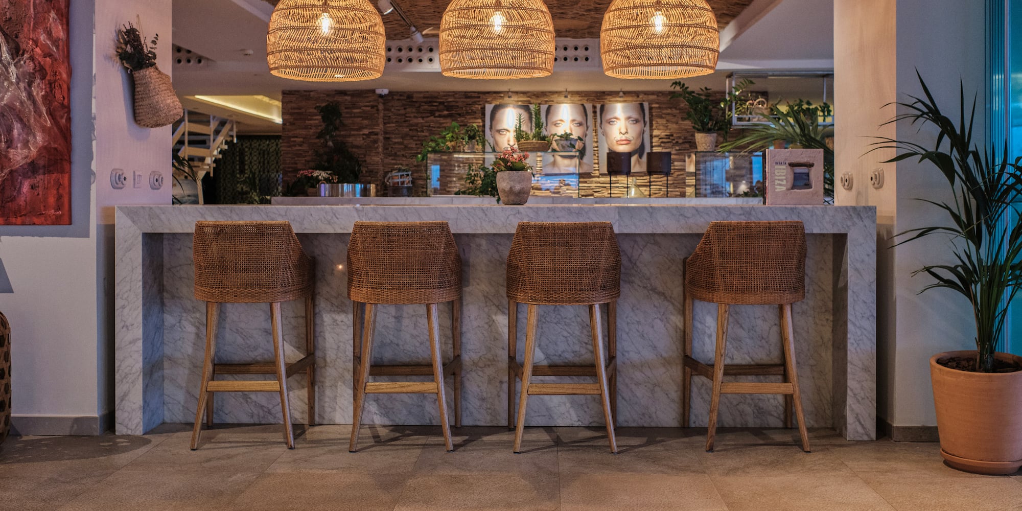 a bar with wicker chairs and a counter
