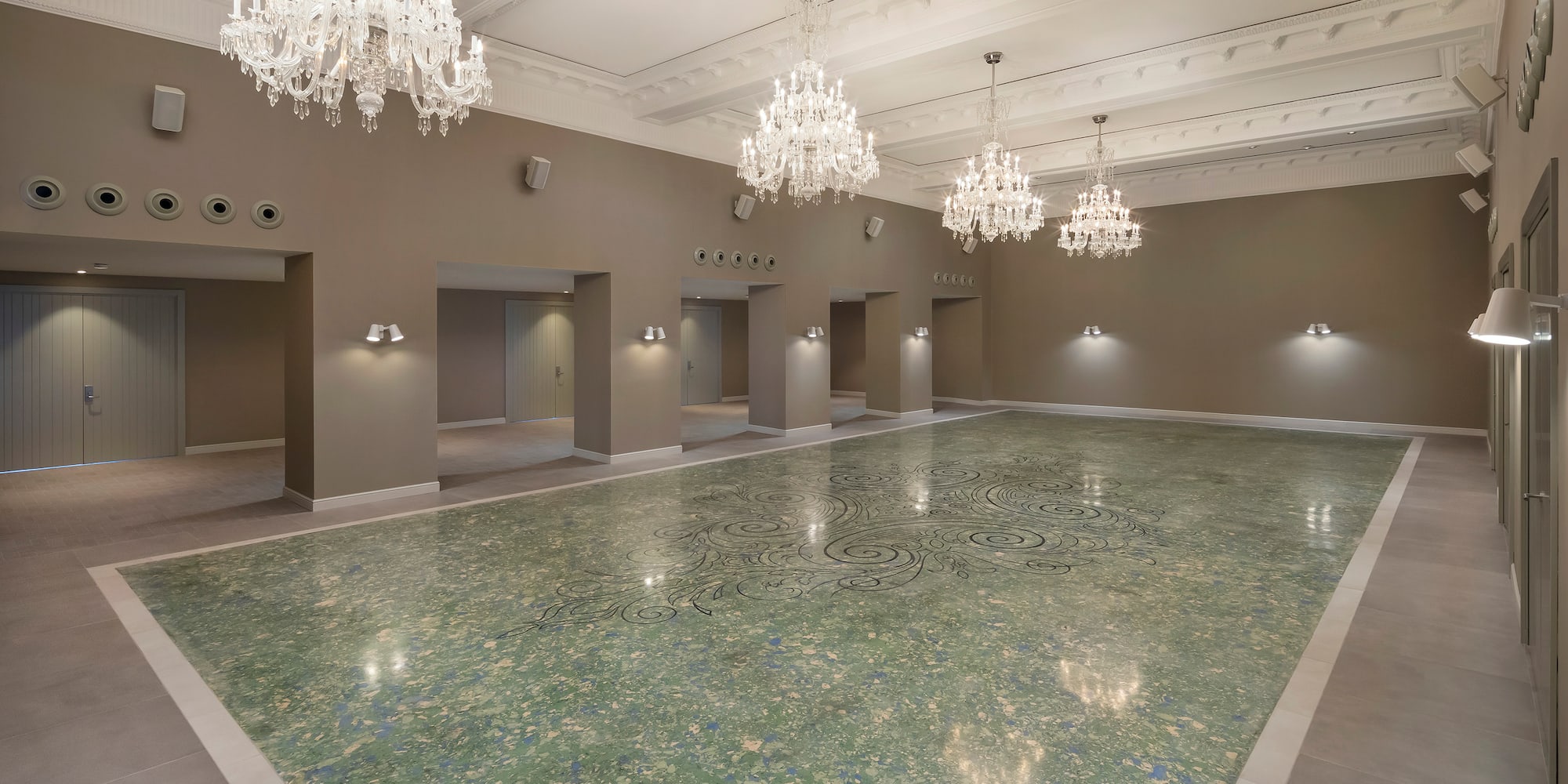 a large room with a marble floor and chandeliers