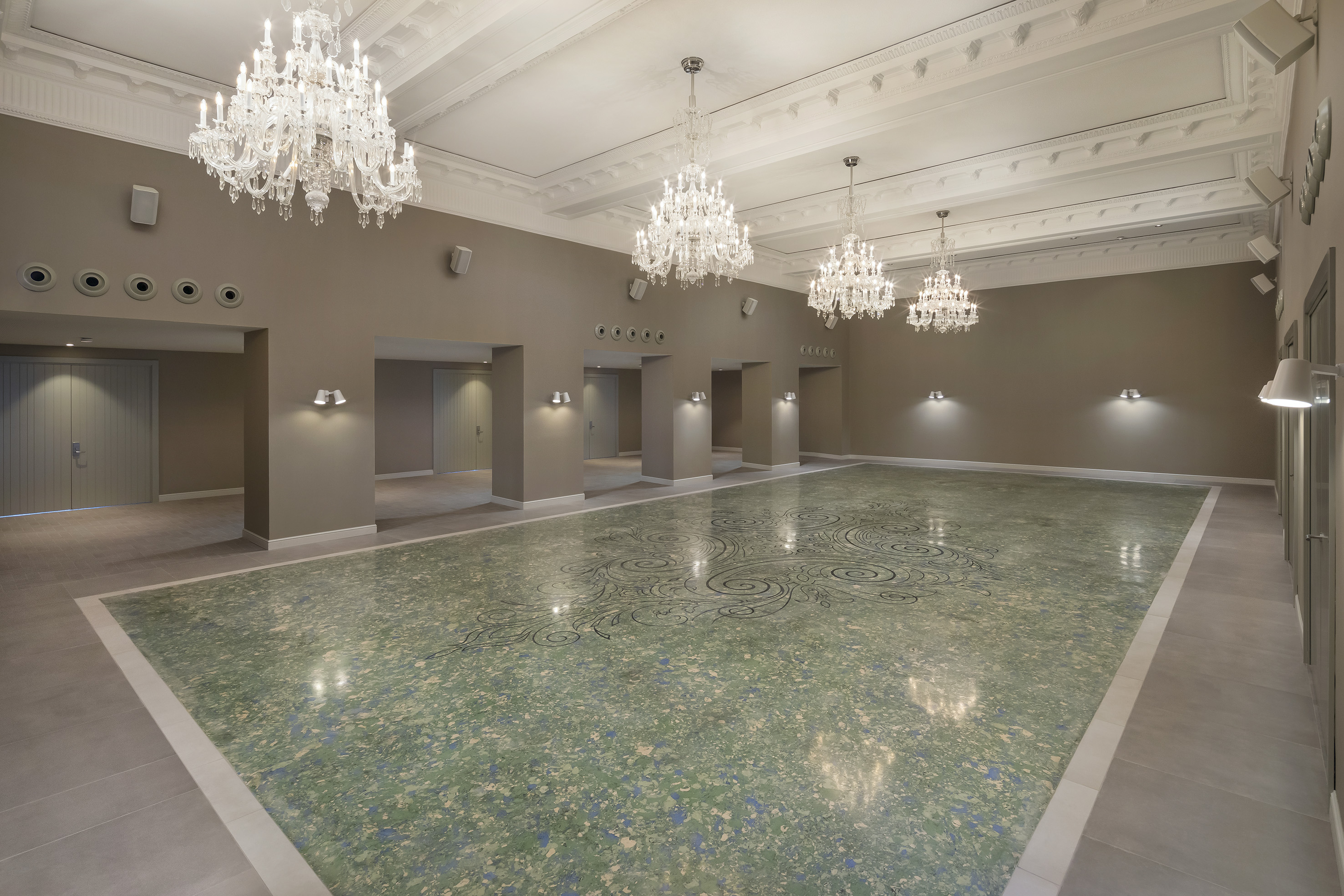 a large room with a marble floor and chandeliers