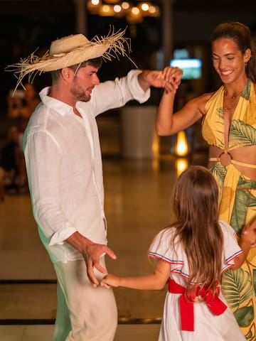 a man and woman dancing with a girl