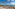 a beach with palm trees and umbrellas