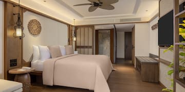 a room with a bed and a television