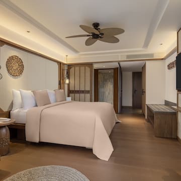 a room with a bed and a television