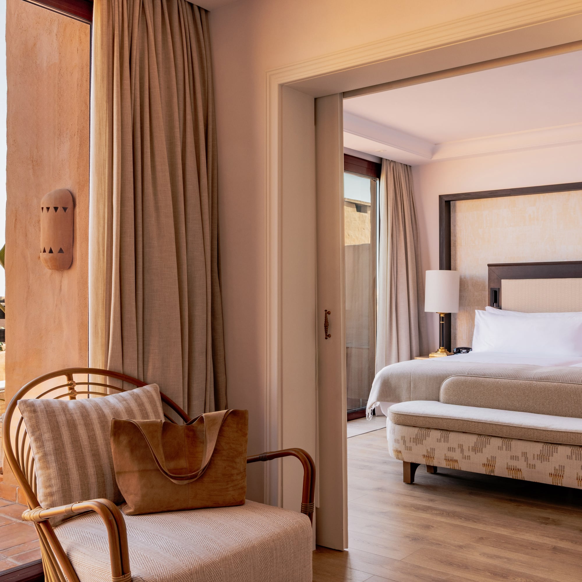 Elegant resort suite with private terrace access and spacious bedroom.