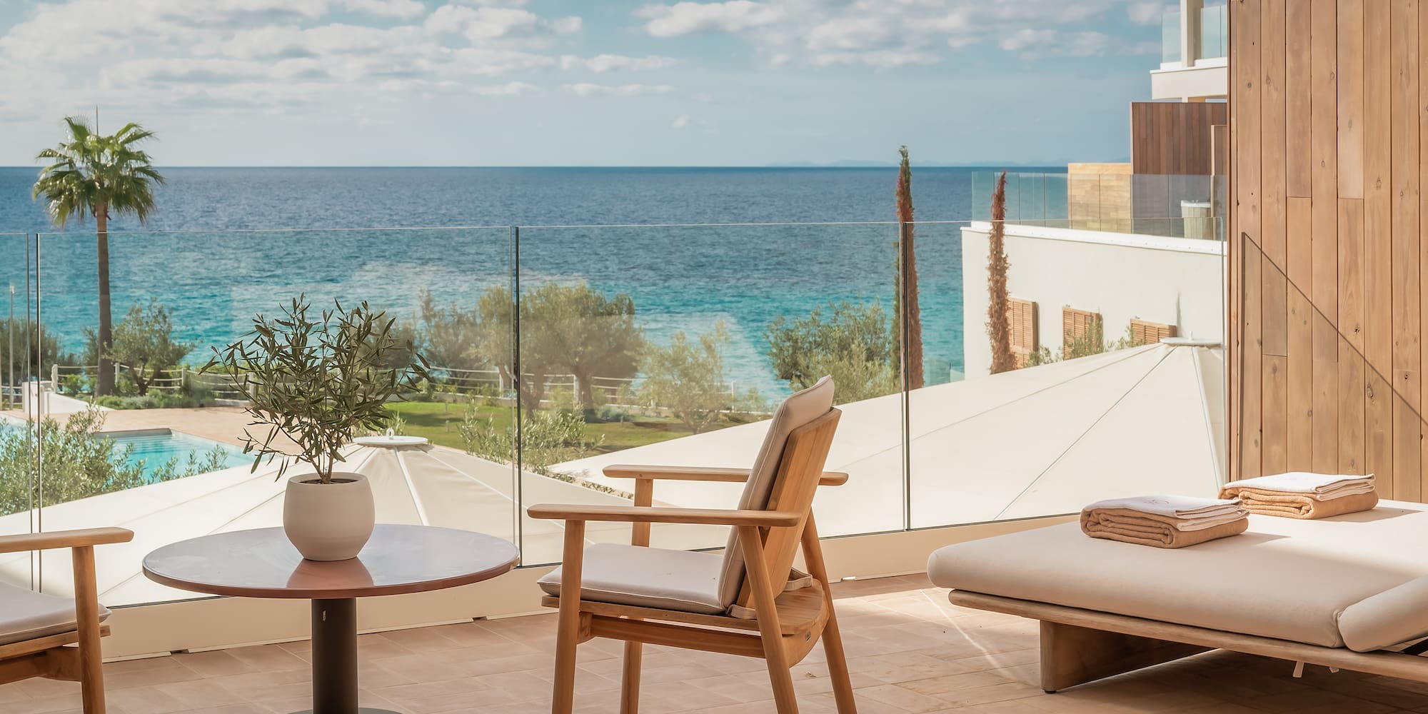 a chair and table with a view of the ocean