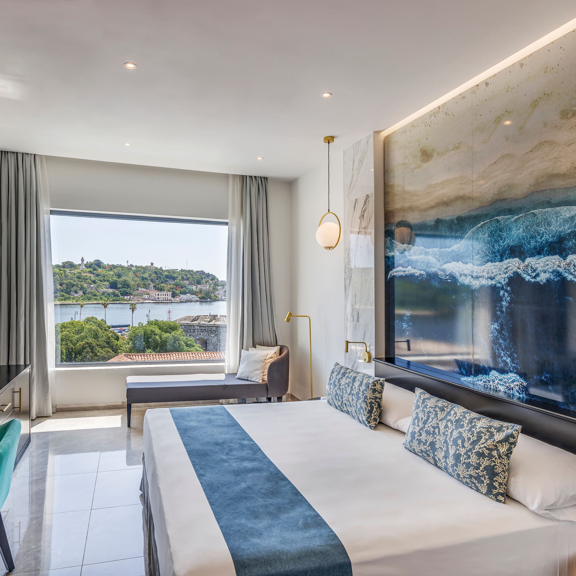 a room with a large bed and a large picture on the wall