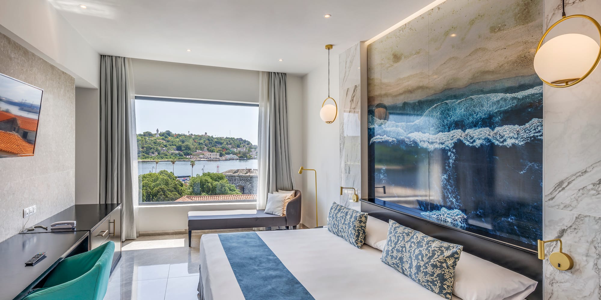 a room with a large bed and a large picture on the wall