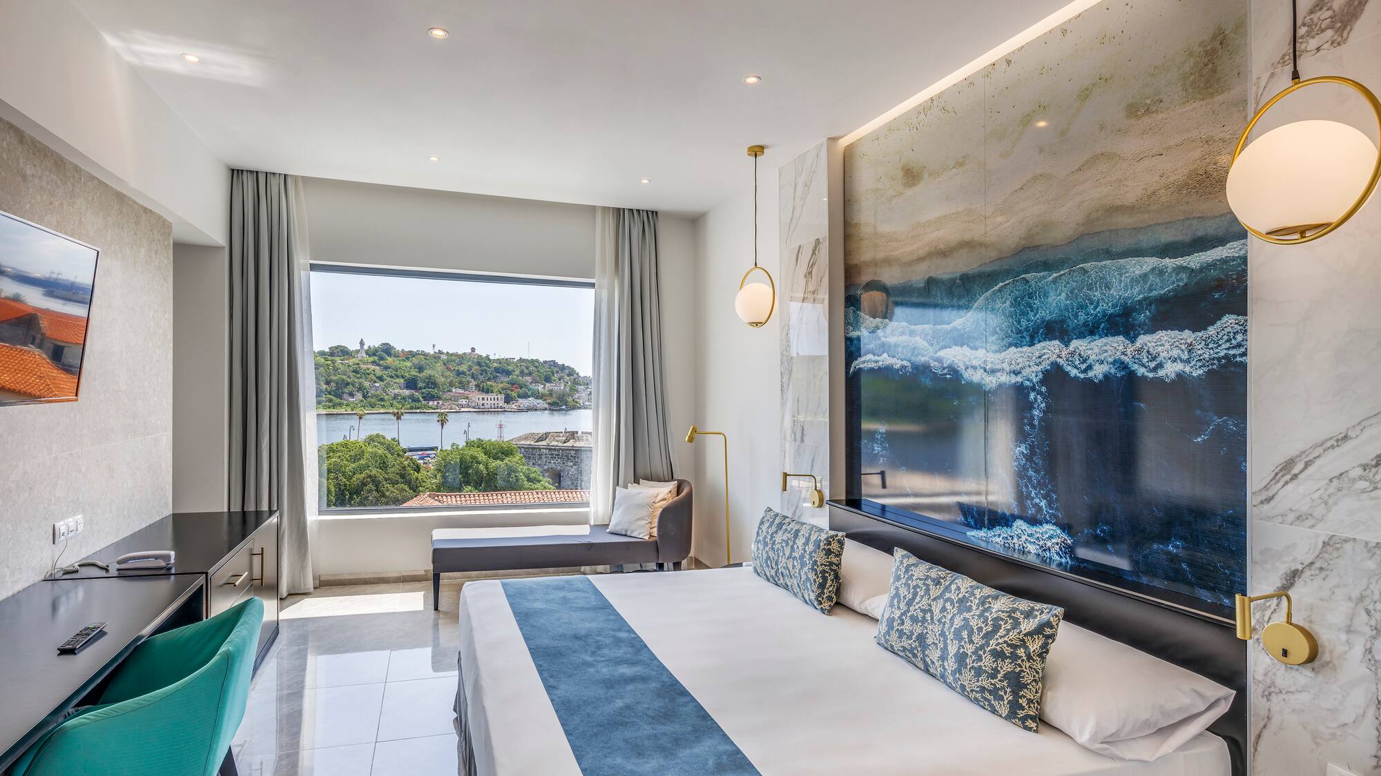 a room with a large bed and a large picture on the wall