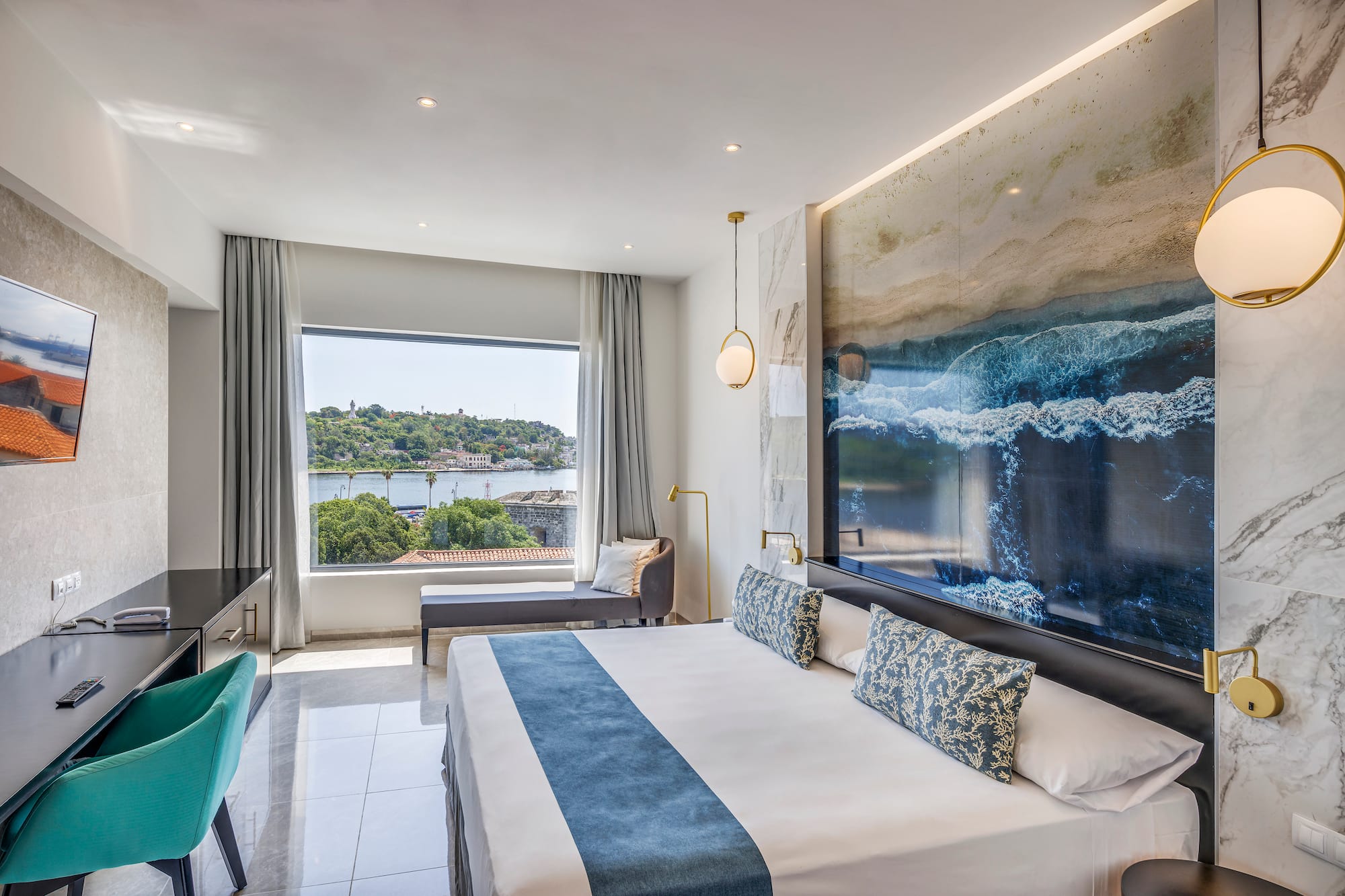 a room with a large bed and a large picture on the wall