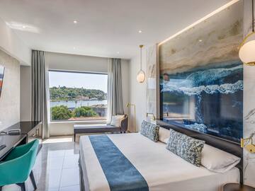 a room with a large bed and a large picture on the wall