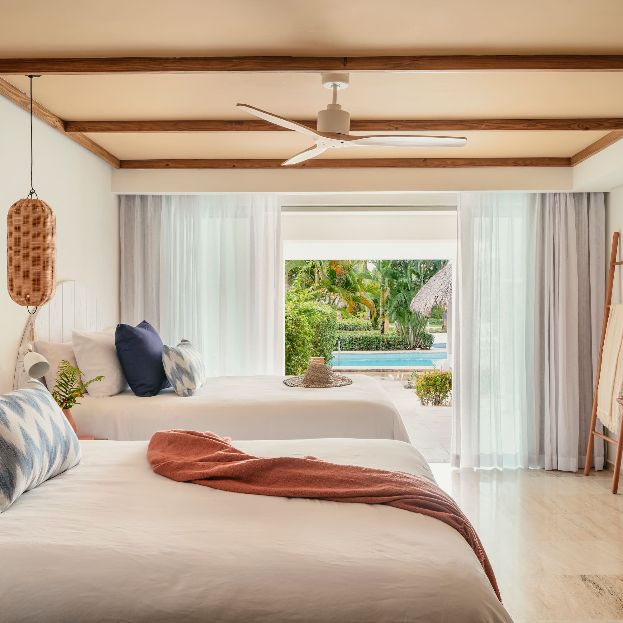 Tropical resort room with two beds and direct pool access.