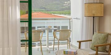 a room with a glass door and a table and chairs