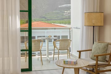 a room with a glass door and a table and chairs