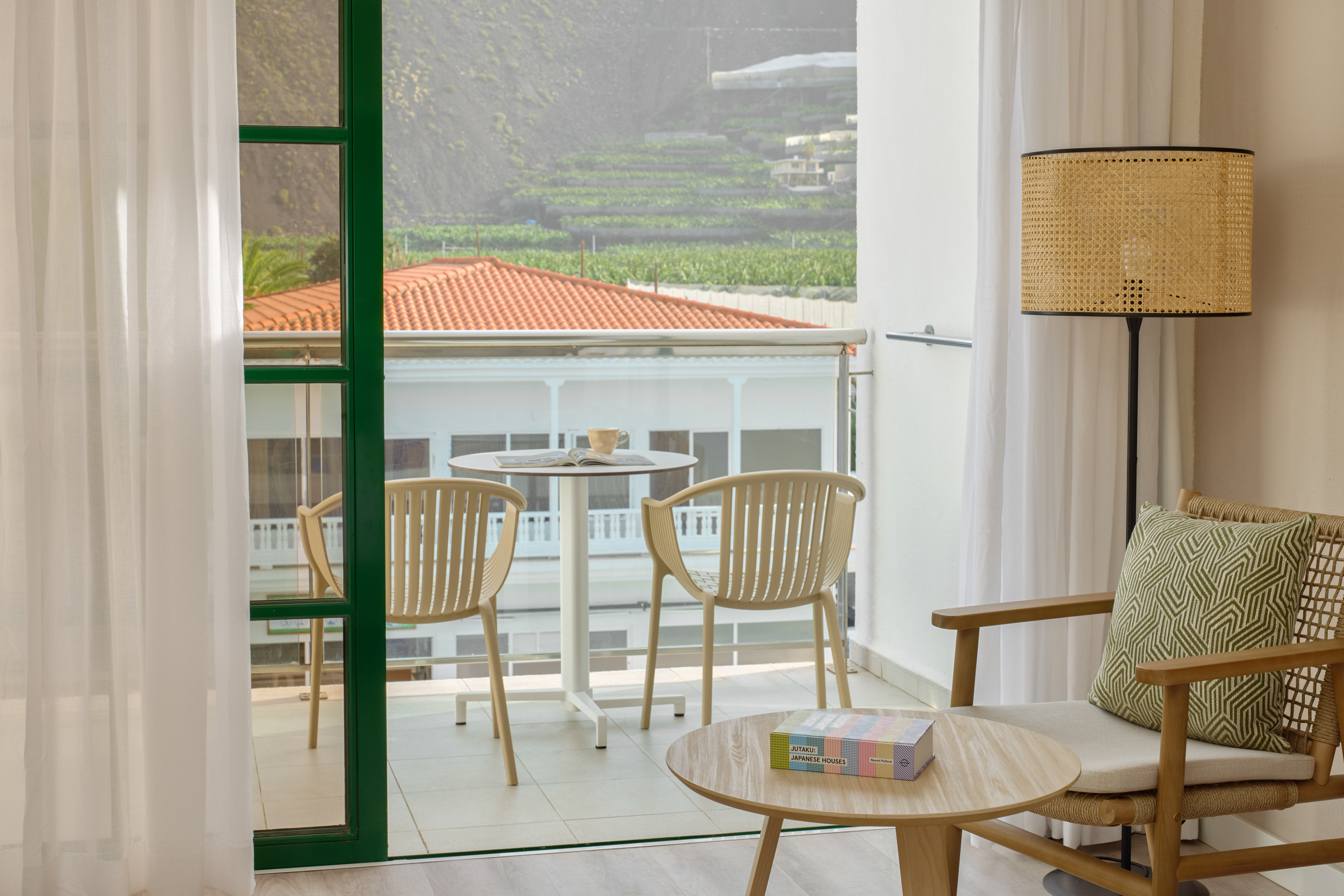 a room with a glass door and a table and chairs