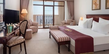 a room with a bed and a television