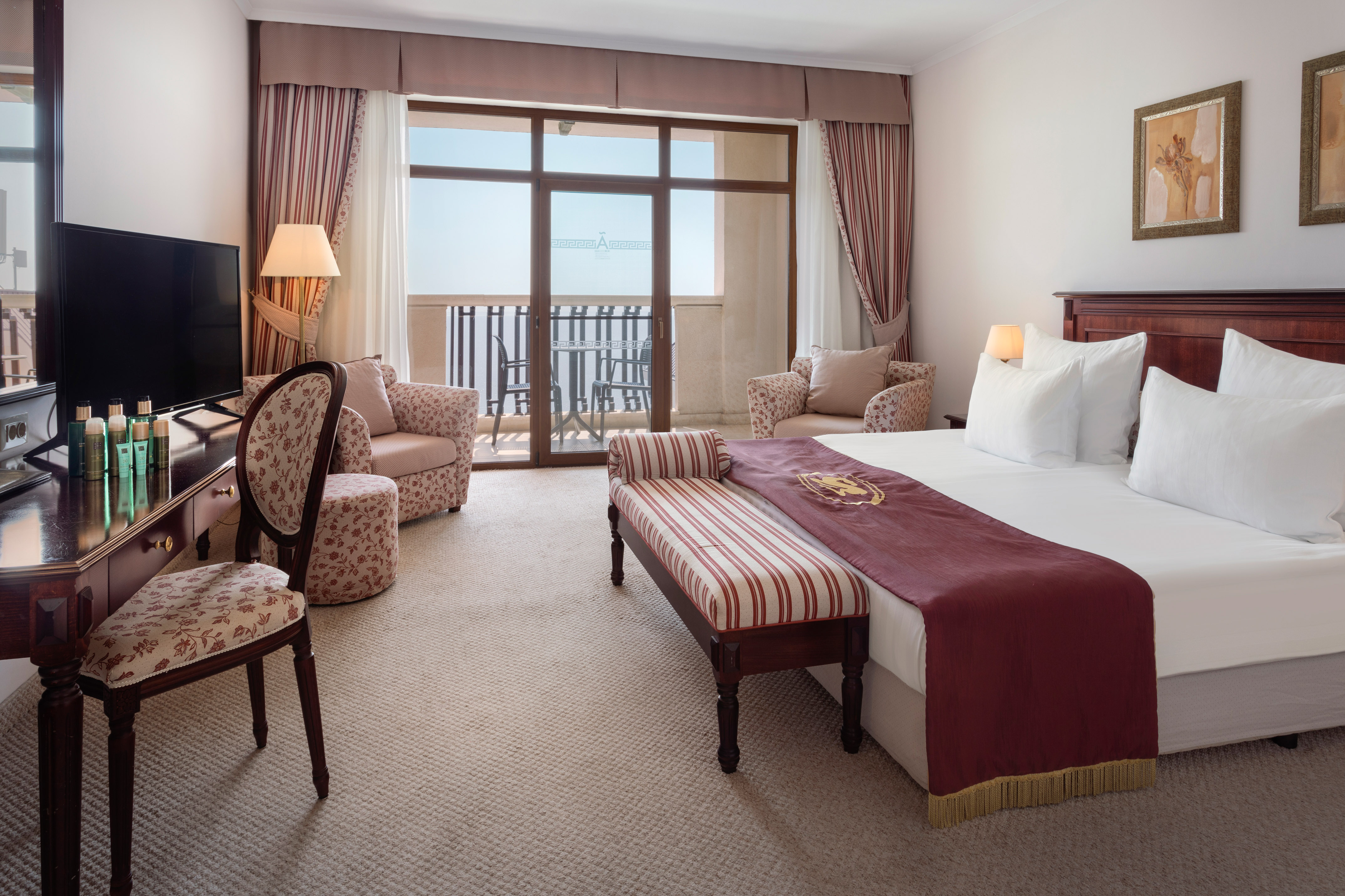 a room with a bed and a television