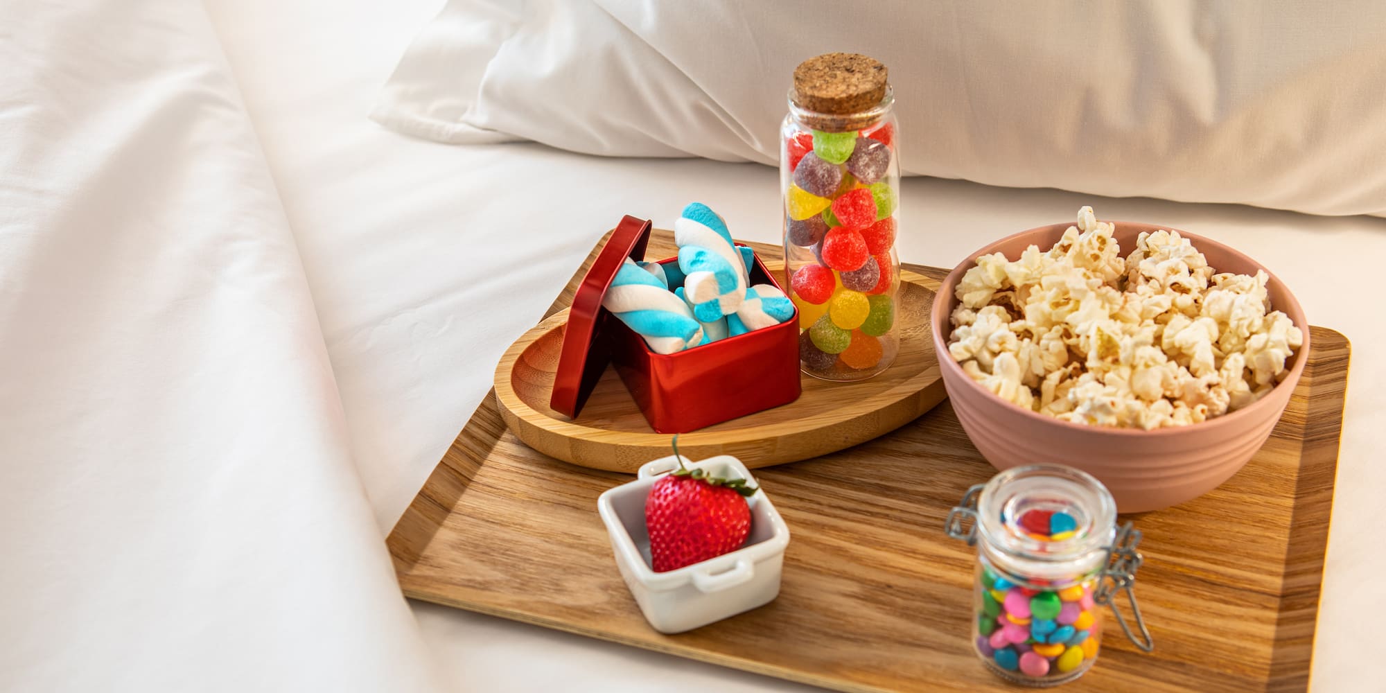 a tray of food on a bed