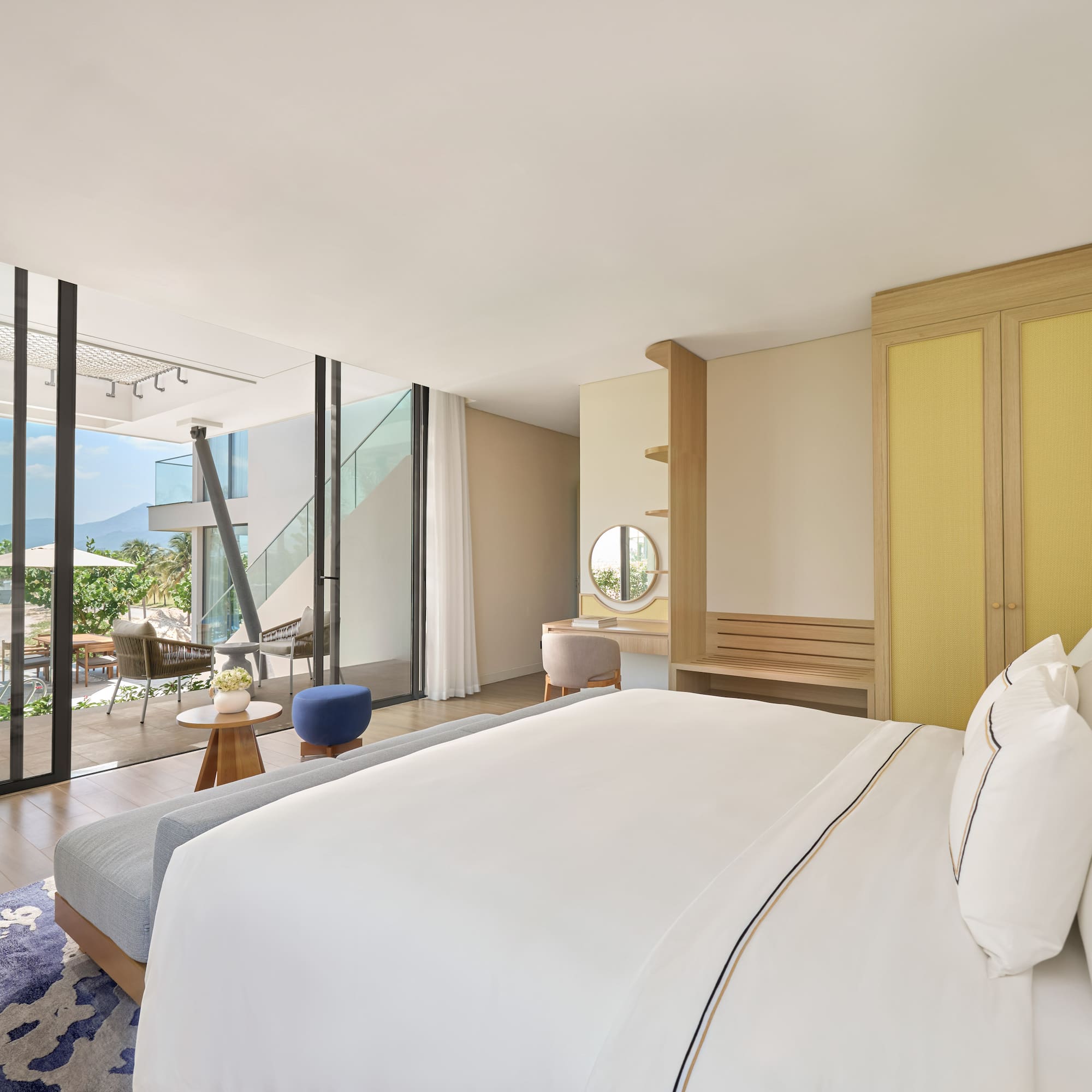 Luxury resort bedroom with private pool patio and mountain views.