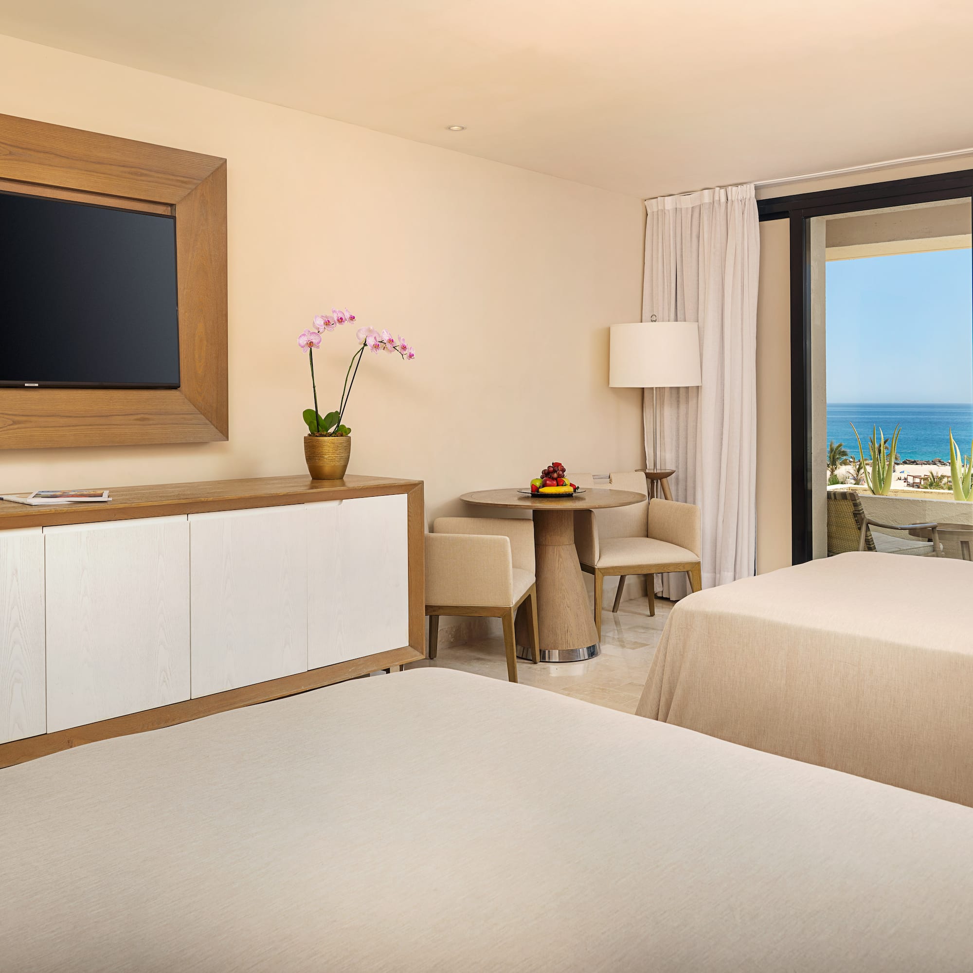 a room with two beds and a television on the wall