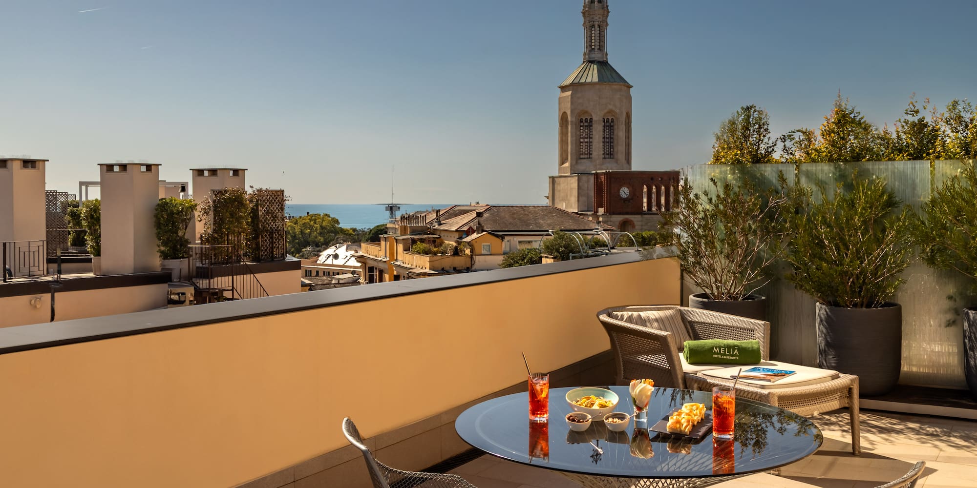 a table and chairs on a balcony overlooking a city