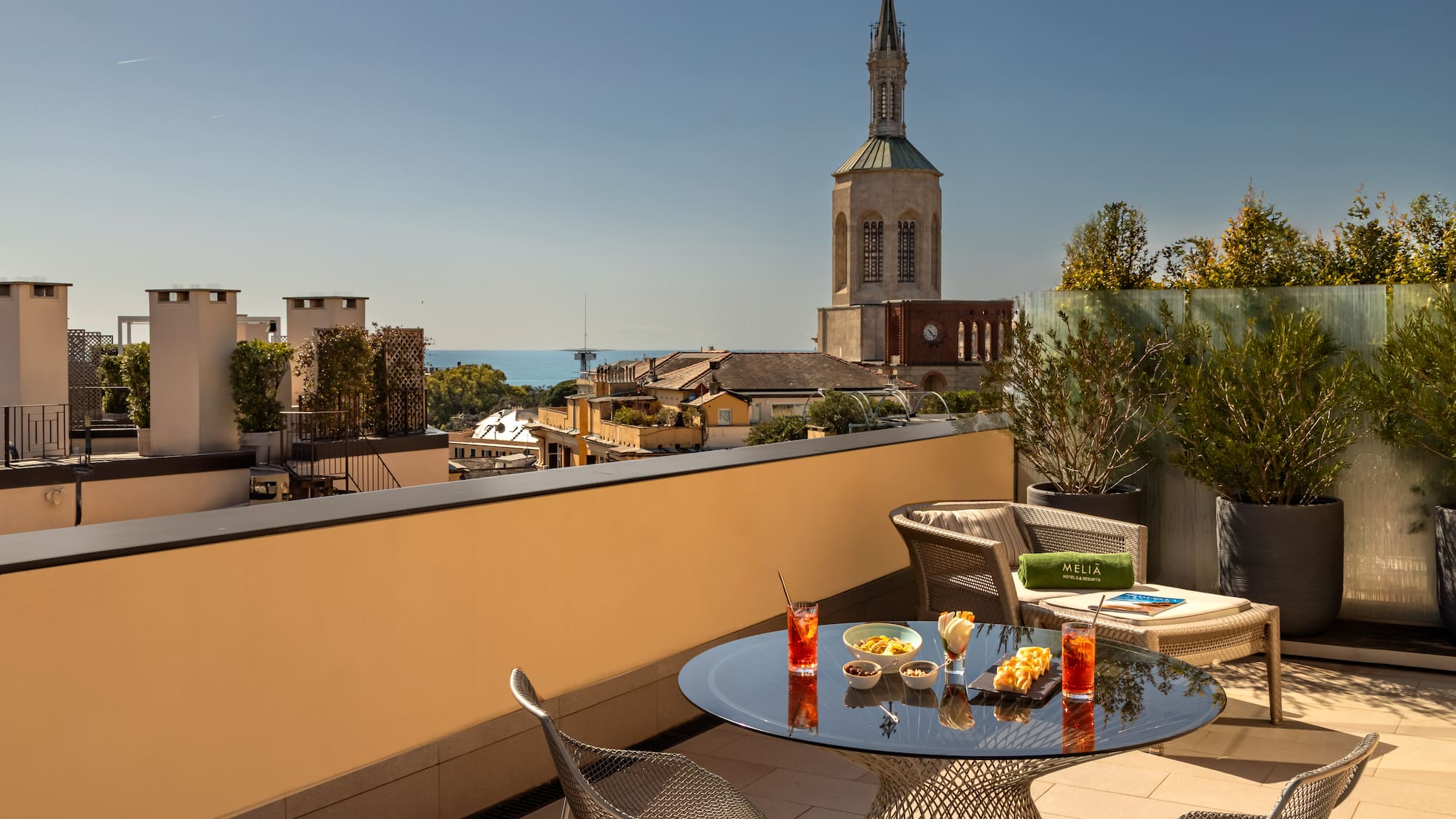 a table and chairs on a balcony overlooking a city