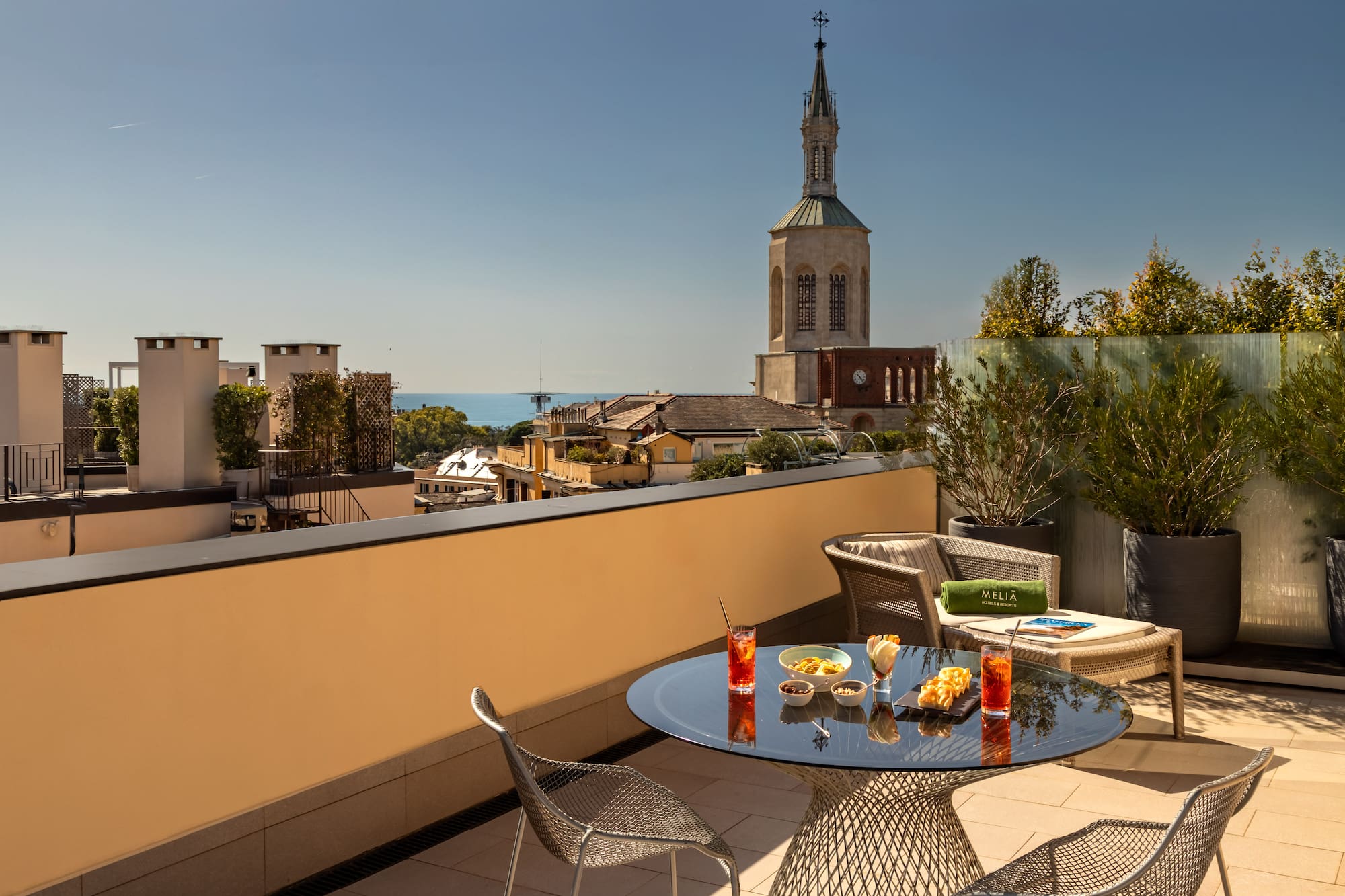 a table and chairs on a balcony overlooking a city