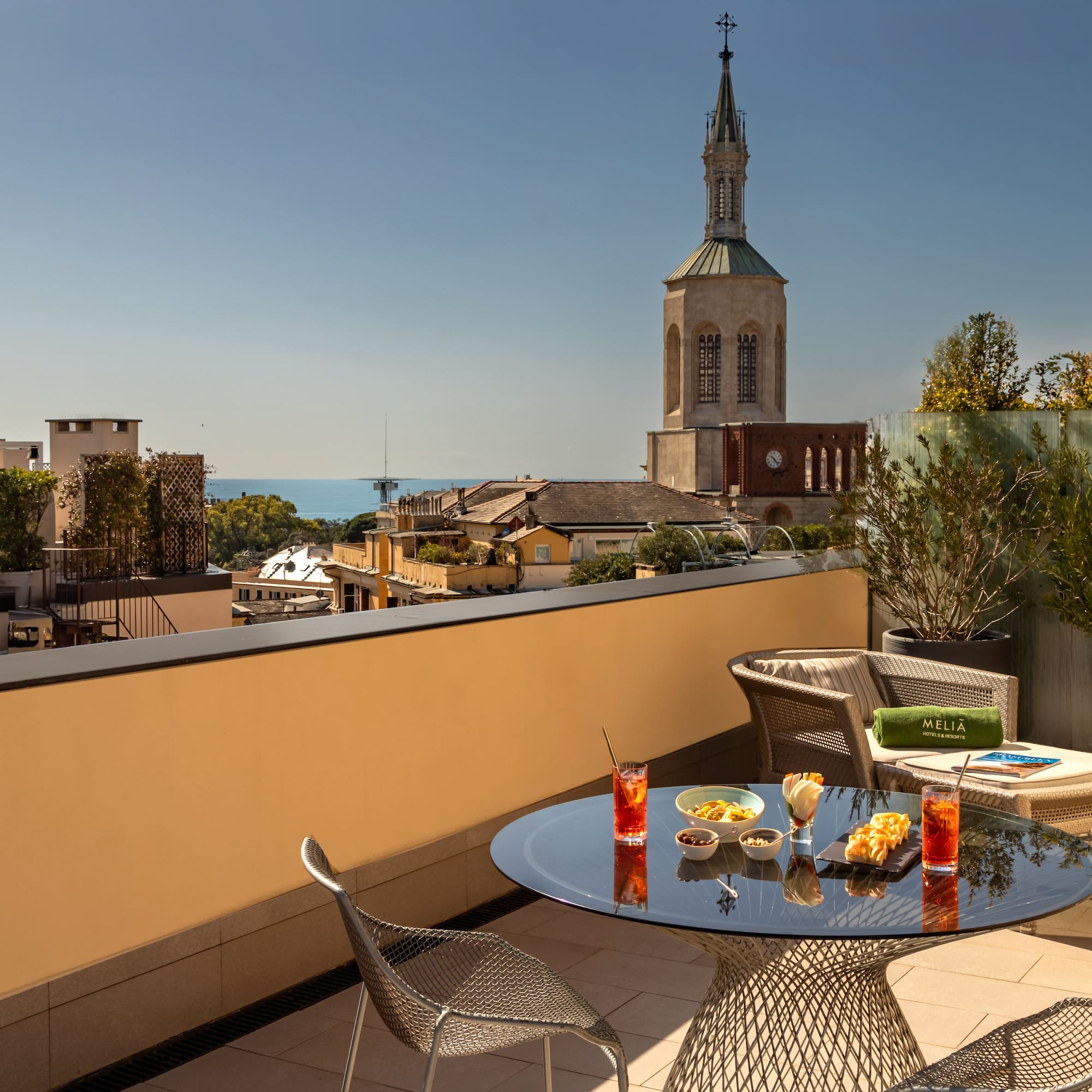 a table and chairs on a balcony overlooking a city