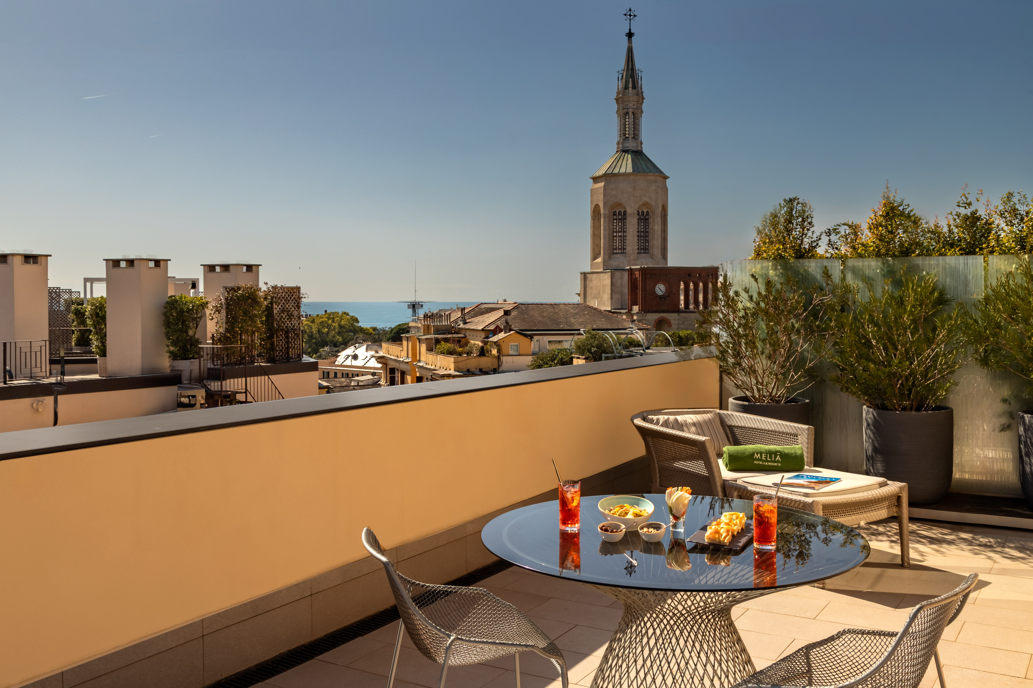 Meliá hotel rooftop terrace with cocktails, snacks, city and sea view.