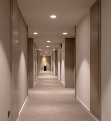 a hallway with a statue on the side