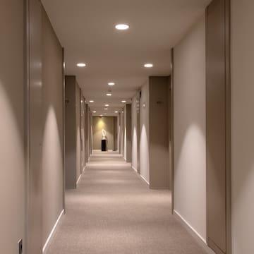 a hallway with a statue on the side