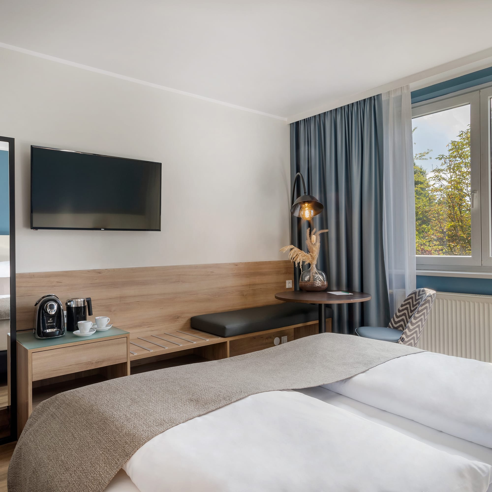 a room with a bed and a television