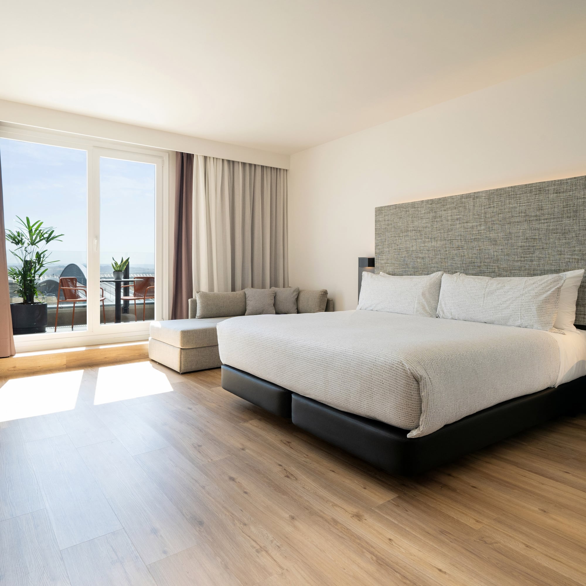 a bedroom with a large bed and a window