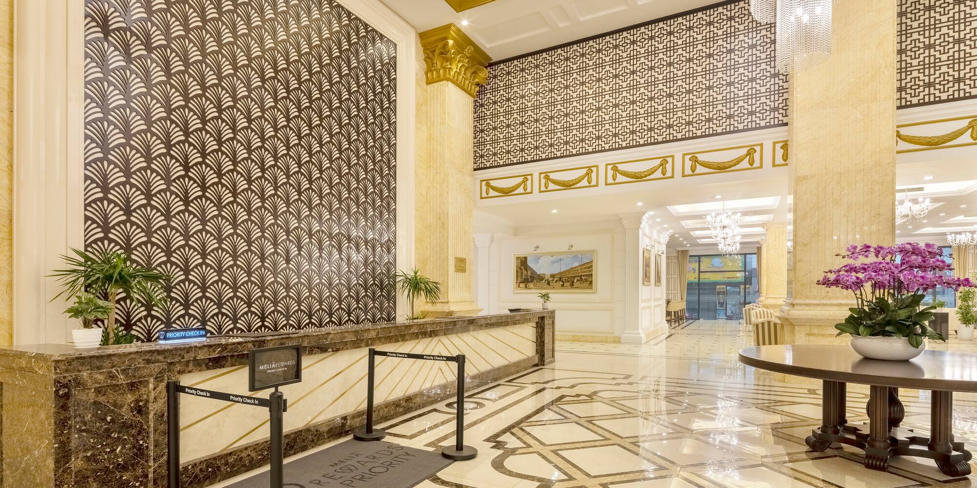 a large hall with a marble floor and a large wall